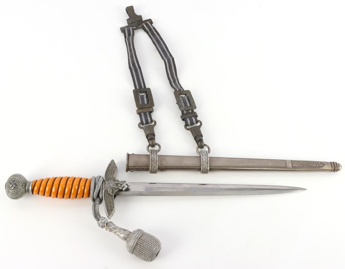 WWII GERMAN THIRD REICH LUFTWAFFE 2ND MODEL DAGGER: Luftwaffe dagger second model. Swastika pommel. Orange bakelite handle. Guard has Reichsadler on one side and dimpled steel on the other. Marked Gustav Spitzer Solingen on blade. Scabbard is dimpled m