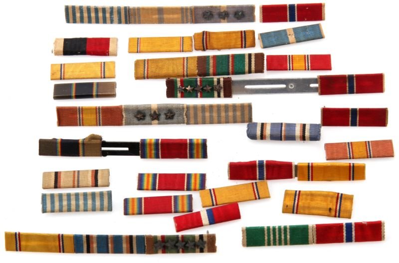 GROUP OF MILITARY RIBBON BARS: Some of the bars include European, African Middle eastern campaign with service stars; Bronze star; WWII Victory Medal, National Defense Service Medal bar; American Defense Medal; United Nations servi