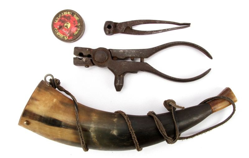 FOUR VINTAGE FIREARMS RELATED ITEMS: Lot of four vintage firearms related items. Two steel bullet molds, one for about .32 caliber bullet, the other for about .31 caliber ball; powder horn, and tin of Flobert blank caps.