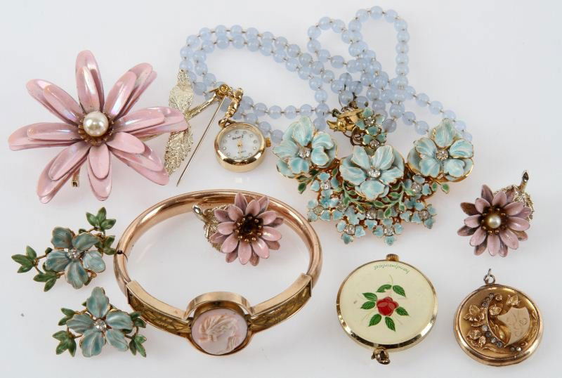 SMALL LOT LADIES COSTUME JEWELRY: One beaded necklace, floral design with matching clip-on earrings. One Pin and earring set, floral design. two pendant watches. One gold plated locket. One gold plated faux cameo bracelet. Condition: