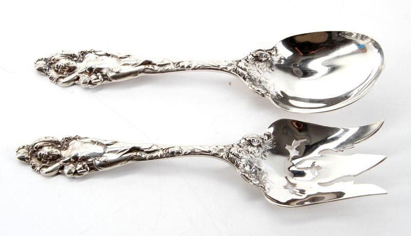 REED & BARTON LOVE DISARMED STERLING SALAD SET: Large heavy Sterling silver salad serving fork and spoon from Reed & Barton. Beautiful workmanship in "Love Disarmed" pattern. Circa 1900. Duly marked and hallmarked on reverse. No monogram. . Size: 1