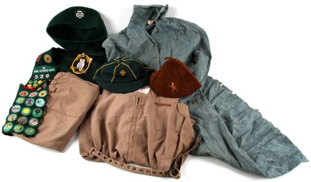 1940'S GIRL SCOUT UNIFORM SASH HAT BROWNIE BEANIE: With original c.1940's buttons, official GS dress, later Brownie beanie, 1970's sash with merit badges and pins, c.1970's Brownie uniform, and a girl scout hat.