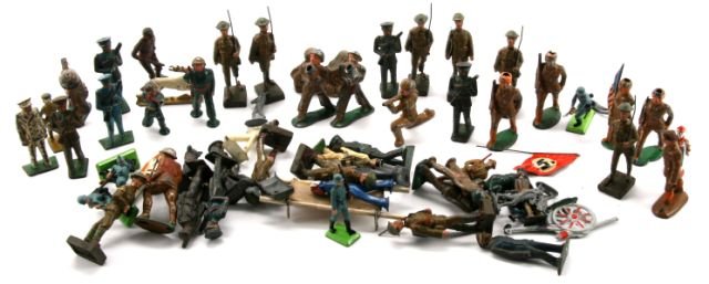 63 PIECE VINTAGE TOY SOLIDERS LEAD AND PLASTIC: Lineol, Britans Deetail, and many unmarked figures with WWI German and American figures, pre-WWI-dressed soldiers, US Navy sailors, a wood and canvas field stretcher, a German shepherd with field satc
