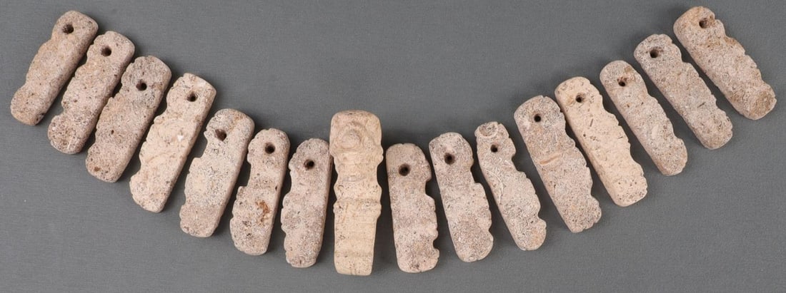 TAINO PRECOLUMBIAN NECKLACE PENDANT STONE LOT: Taino. PreColumbian. Necklace, possibly unfinished. Central pendant is Anthropic, while spacers appear to be abstract human profiles. Pendant measures 2 13/32 inches. Made from what appears to be soli