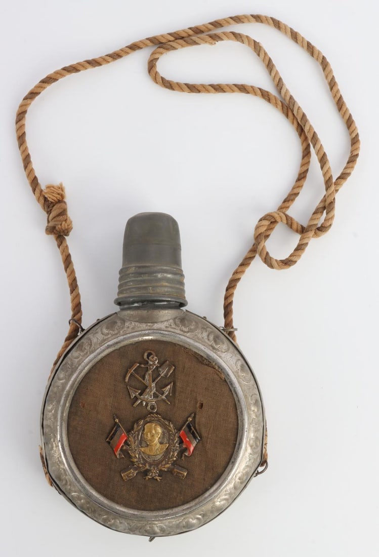 WWI GERMAN SECOND REICH REGIMENTAL OFFICERS FLASK: German officer's regimental flask from WWI. Pewter flask with aluminum cup and cap. Front side has shovel and pick crossed over an anchor with brass portrait of Kaiser Wilhelm I flanked by German Impe