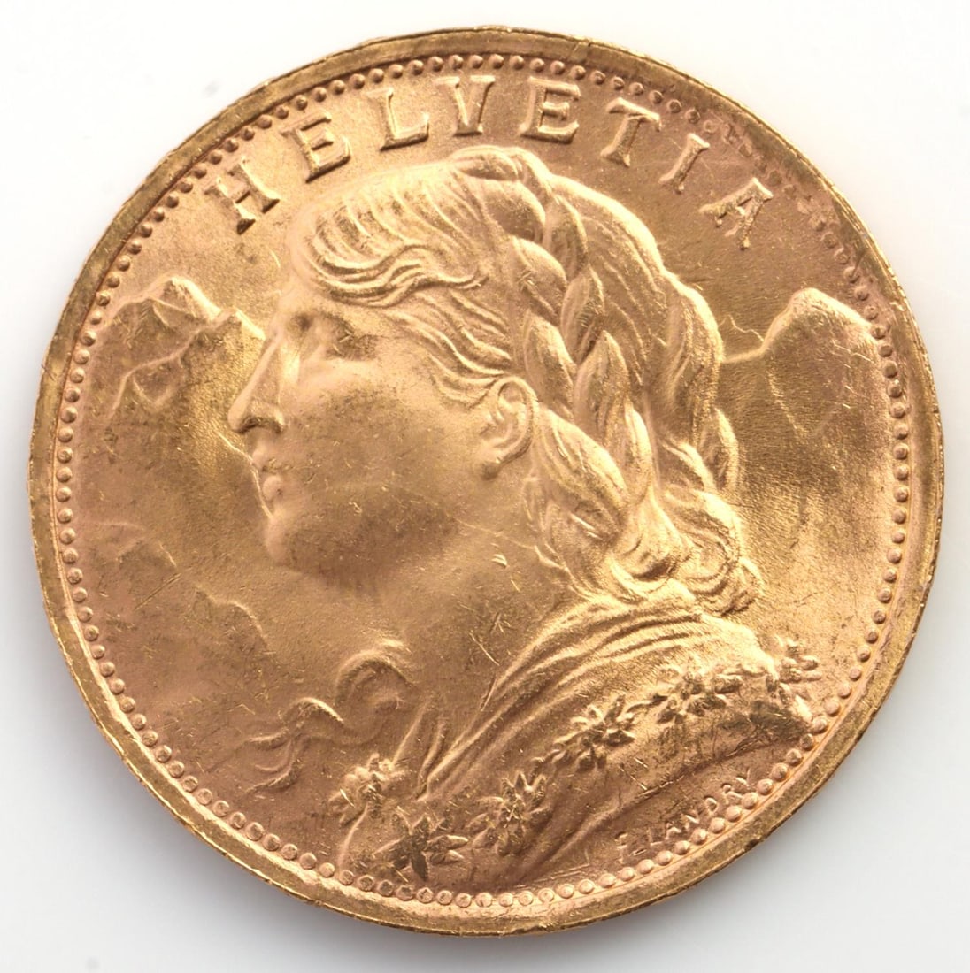 GOLD HELVETIA SWISS 1935 20 FRANCS COIN UNC: Helvetia gold coin. 900 gold, 6.4 grams. Brilliant Uncirculated. This lot has a reserve.