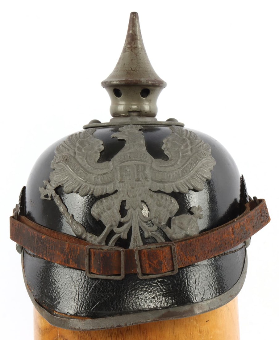 IMPERIAL GERMAN UNISSUED PRUSSIAN PICKELHAUBE: Prussian pickelhaube spike helmet. Interior has ink stamps for maker "Ph. Hoffman Berlin," year "1916" and size "53." Fine condition, appears unissued. Part of visor rim is bent away from visor. Some