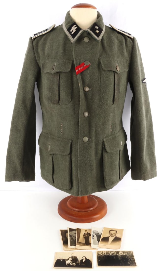 WWII LATVIAN WAFFEN SS M40 FIELD TUNIC: Field gray tunic with collar tabs, shoulderboards, Latvian patch, and Reichsadler. Interior ink stamped with "41/70 98 44/61". Pebbeled buttons. Comes with photograph of the owner of the tunic or indi