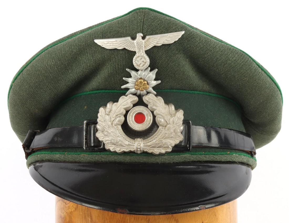 WWII GERMAN THIRD REICH NCO MOUNTAIN TROOP VISOR: Green piping on field gray cloth with black leather strap and black visor. Reichsadler, totenkopf, and edelweiss on front. Brown interior with torn liner. Diamond sweat shield. Approx. size 7. Very go