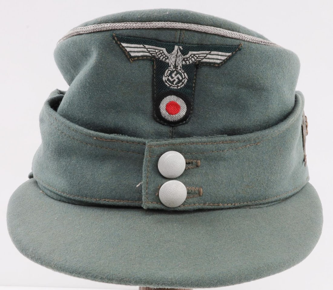WWII GERMAN GEBIRGSJAGER OFFICERS MOUNTAIN CAP: Third Reich Heer Gebirgsjager officer's bergmutze, or mountain cap, in blue gray wool with silver bullion piping. Magnetic metal edelweiss insignia is attached to left side at five separate points wit
