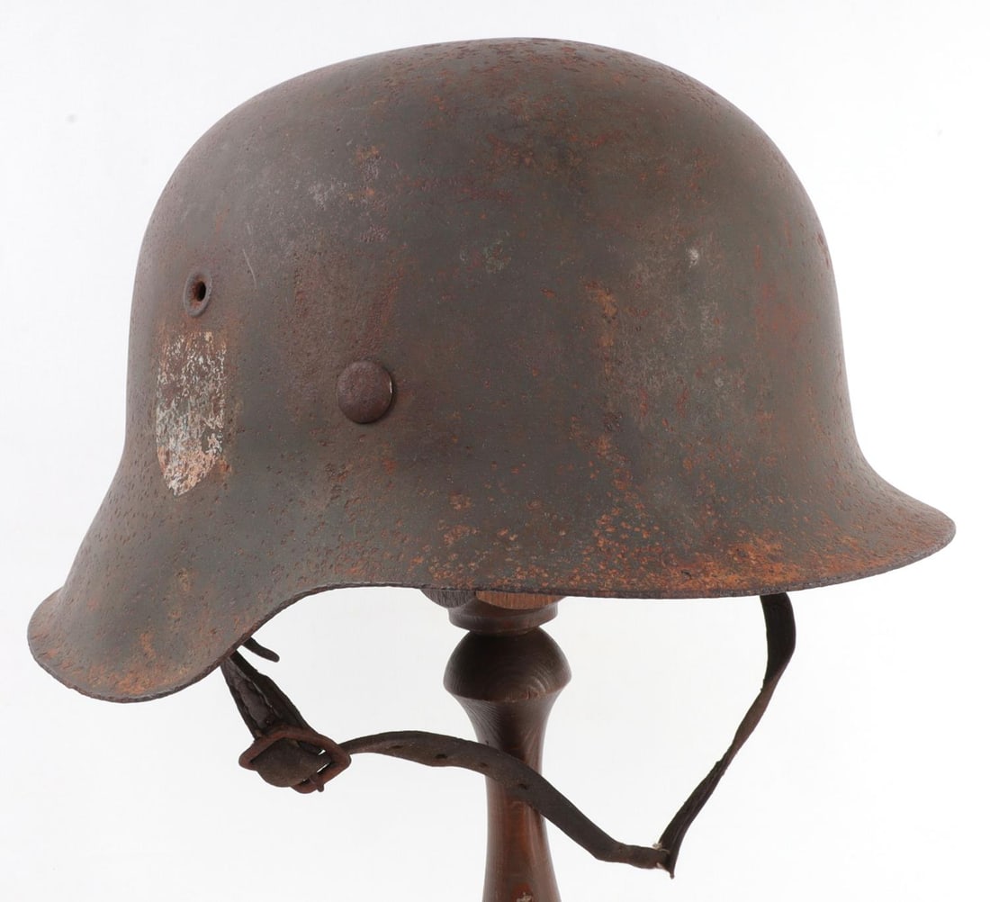 WWII GERMAN THIRD REICH STAHLHELM M42 HEER HELMET: Model 1940 Stahlhelm. Faded SS sig-runes decal on right hand side of helmet. Brown leather lining. Stamped 3035. Liner is 22 inches around. Very good, original condition. This lot has a reserve.