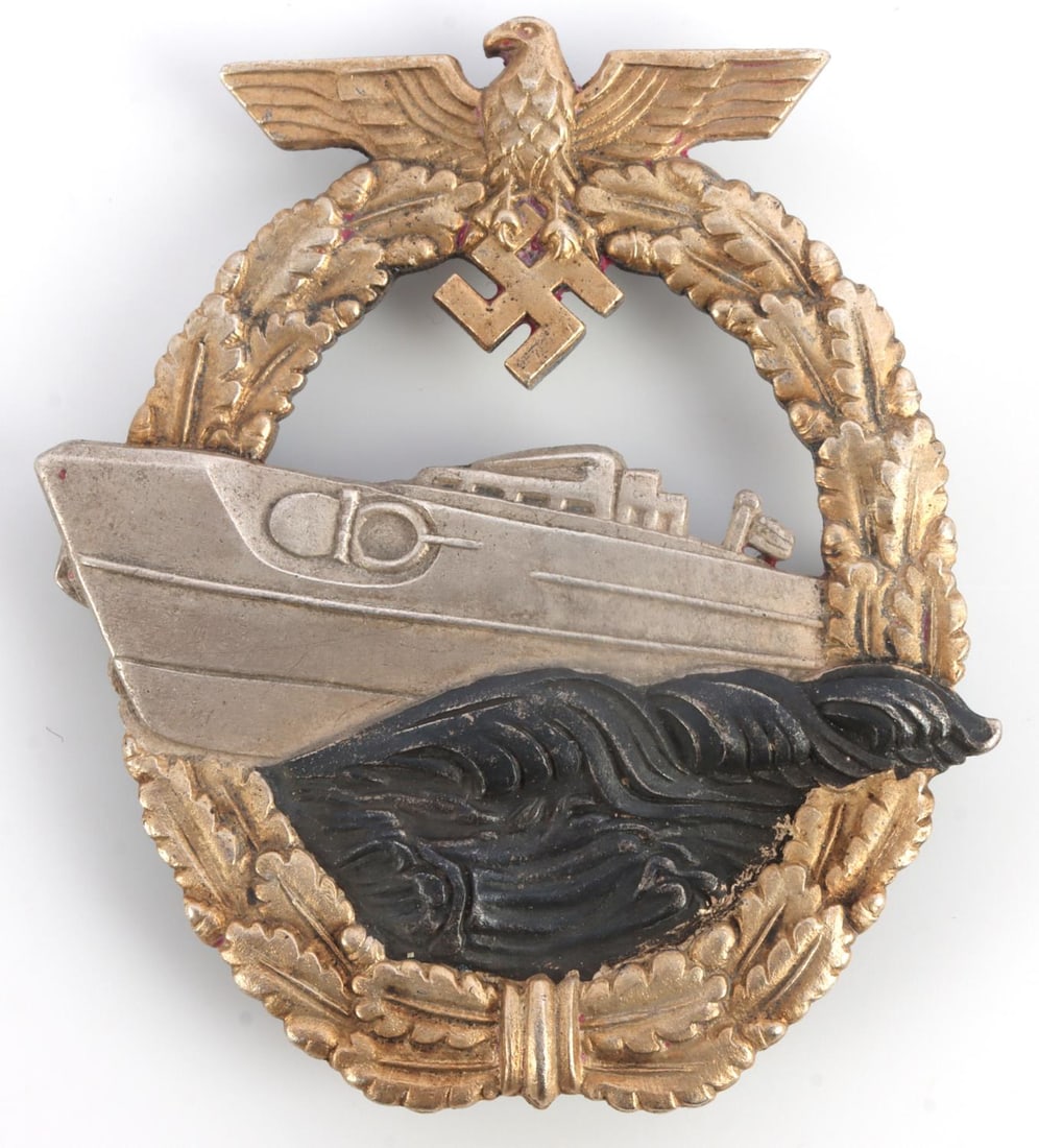 WWII GERMAN NAVAL KREIGSMARINE 2ND E BOAT BADGE: WWII German Third Reich Naval Kreigsmarine 2nd E-Boat Badge. Reverse marked ''Fec. W. E. Peekhaus Berlin Ausf. Schwerin Berlin 68.'' Wide horizontal pin back with C-hook closure. Nickel construction w