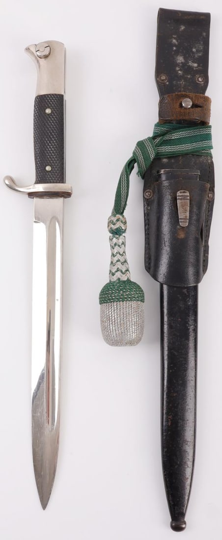 WWII GERMAN HEER NCO DRESS BAYONET BY EMIL VOOS: Third Reich Heer NCO's long model quillback bayonet with scabbard, frog, and portapee. Ricasso has maker's mark of Emil Voos, Solingen. Well-preserved nickel steel blade with zinc quillon, black bakel