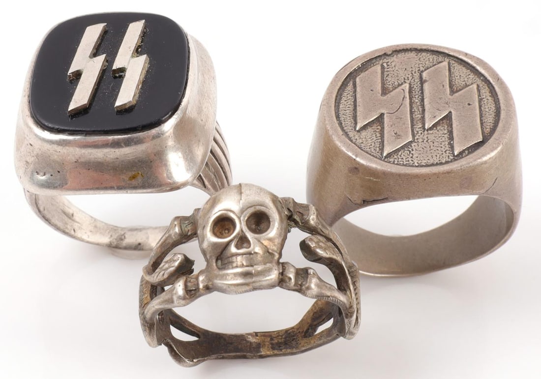 3 WWII GERMAN THIRD REICH SS & TOTENKOPF RING LOT: Lot of THREE (3). 1) SS ring with sig-runes in silver and onyx. Size 9.25. 13.1 grams. 2) SS ring with sig-runes. Size 9.75. 20.9 grams. 3) Totenkopf death's head ring with snakes winding up the colum