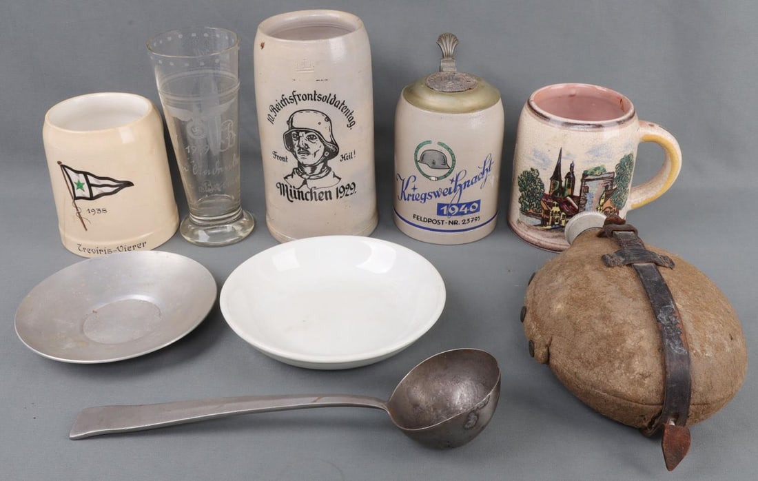 LOT 9 WWII GERMAN THIRD REICH DECORATED STEIN MESS: NINE (9) piece lot of German Third Reich mess items and decorated drink ware. Includes 1940 Winter War stein with finely illustrated stahlhelm, 1941 aircraft mechanic stein, steel ladle stamped with s