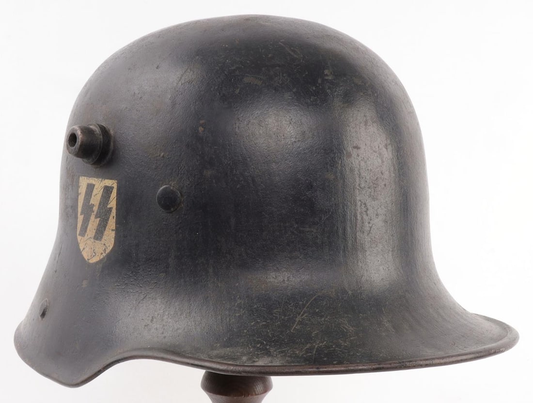 WWI M18 STAHLHELM TRANSITIONAL SS DOUBLE D HELMET: Imperial German model 18 Stahlhelm. Batch number BF62. Was painted black and had NSDAP & SS decals added later, along with its original lining replaced with light leather interior. Liner is 23 inches.