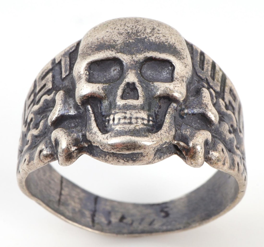 WWII GERMAN THIRD REICH WESTWALL TOTENKOPF RING: German totenkopf ring with 'WESTWALL' (the Siegfried Line) written across mount, separated by a death's head. Silver tested. Size 10.5. 5.839 grams. Very good condition. Unauthenticated, sold "as is."