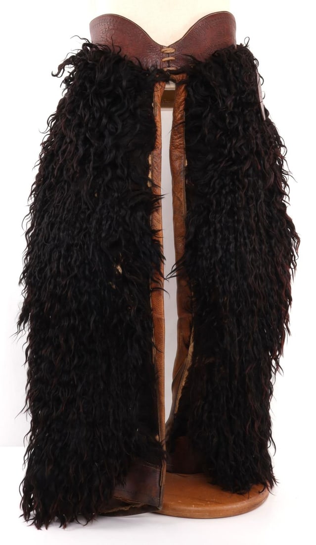 RARE BLACK WOOLY ANGORA SHEEP BATWING CHAPS: Pair of black angora wooly sheep chaps. Chaps are in the batwing shape. Produced by Oregon Harness in the first half of the 20th century. Wait portion and belt is capable of reaching 34 to 45 inches. 