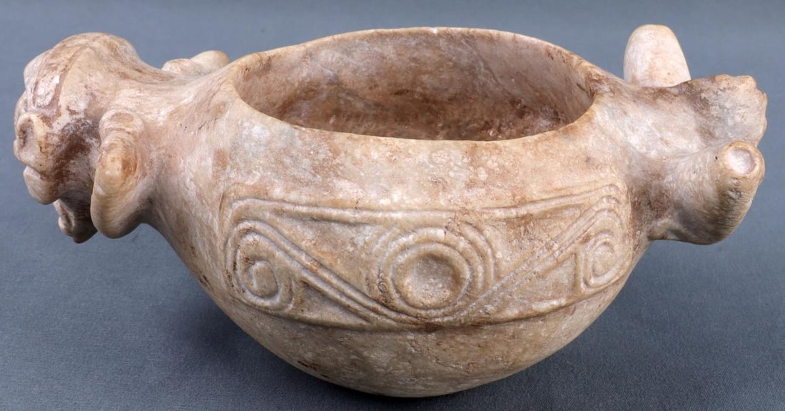 TAINO PRECOLUMBIAN STONE ANTHROPIC VESSEL: Taino Precolumbian anthropic stone cohoba vessel, ca. 1000-1500 AD. 6.5 (L) X 3.75 (W) inches. Provenance: Formerly in the collection of Alfred Carrada, acquired from Dan Pucara in the 1970s. This lot