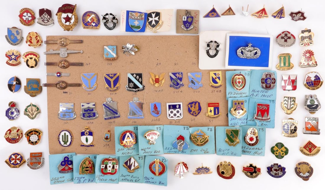 86 PIECE LOT WWII US DUI INSIGNIA PIN COLLECTION: Lot of eighty-six (86) pieces. Multi-conflict distinctive unit insignia collection. Mostly pinch-back pins. Good condition. A few pins are scratched or chipped.