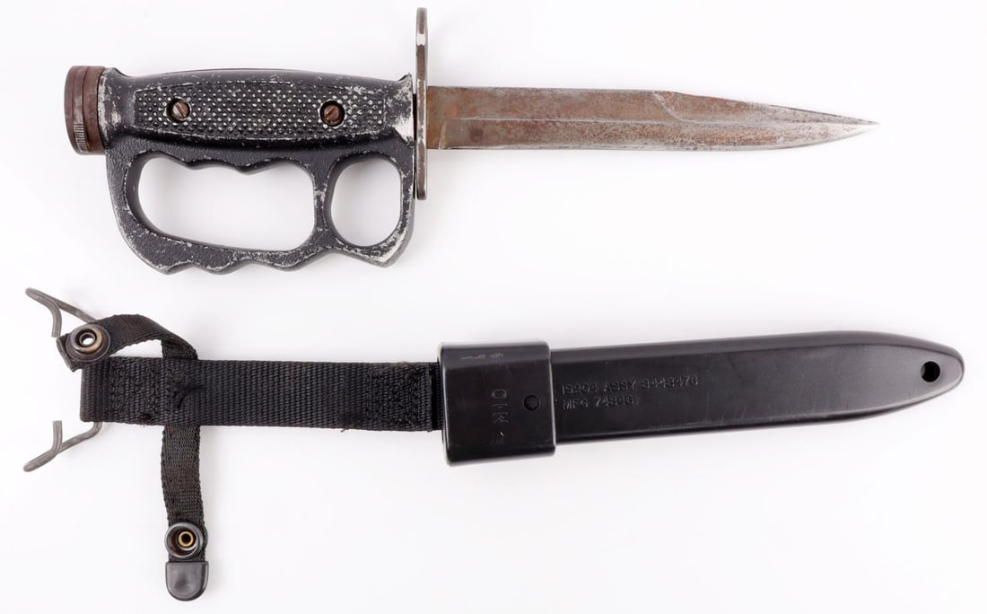 VIETNAM M4 CAMILLUS KNUCKLE DUSTER BAYONET KNIFE: M7 bayonet with experimental knuckle duster attachment, sloping Yataghan style blade and the stamp 'M4 Camillus,' indicative of a previous bayonet being used inside of the M7 duster grip. Handle is ca