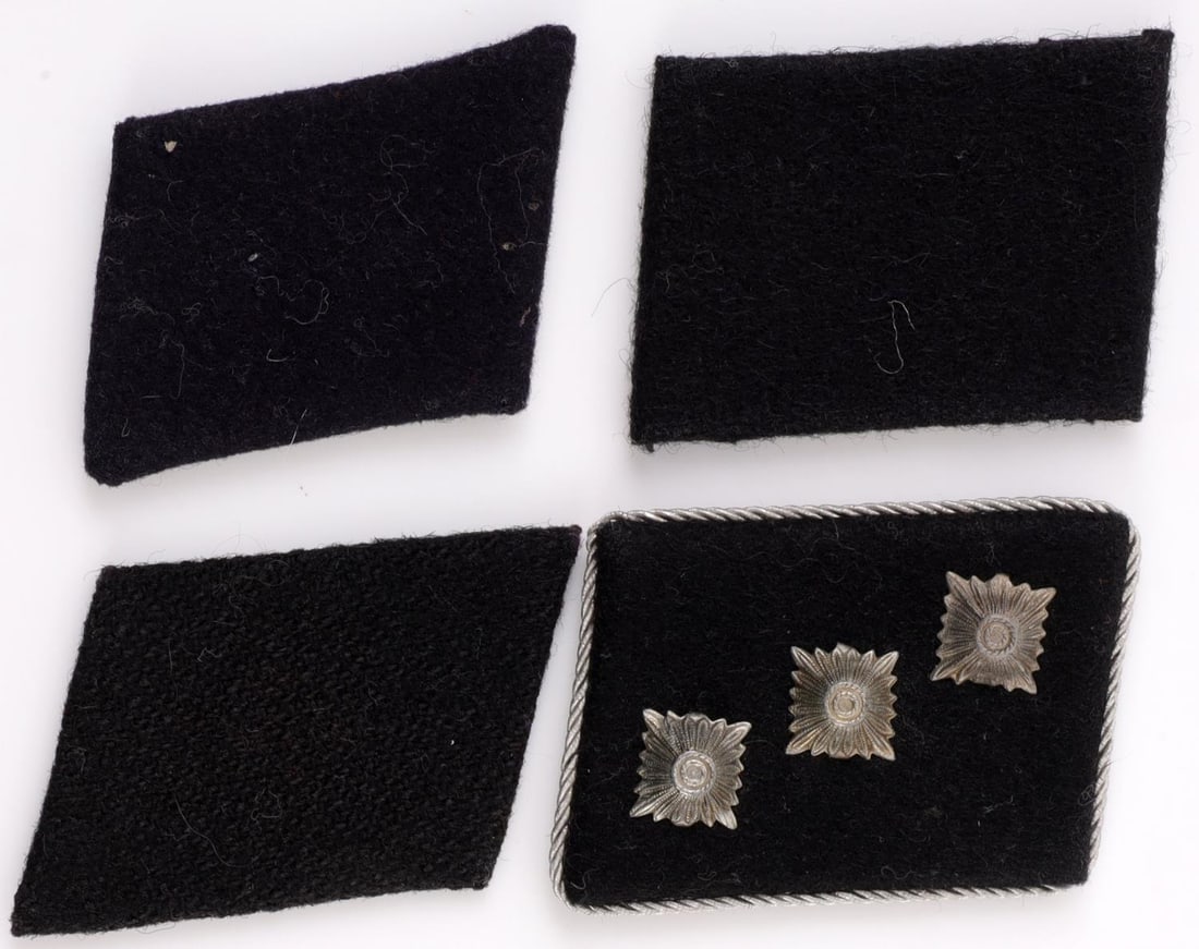 LOT 4 WWII GERMAN SS COLLAR TABS UNTERSTURMFUHRER: Lot of FOUR (4). Includes three (3) SS Mann collar tabs (one stamped "12", one stamped "16", one unmarked) and one (1) SS Untersturmfuhrer unmarked collar tab. Tabs measure approx. 1.75 X 2.25 inches 