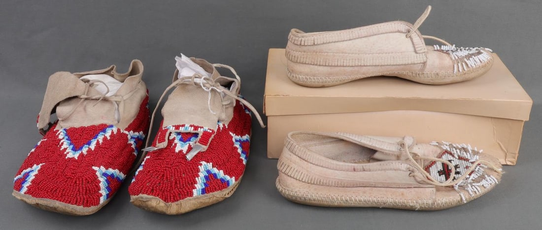LOT OF 2 NATIVE AMERICAN LEATHER MOCCASINS: Lot of TWO (2). 1) Men's leather moccasins. Red, blue, and white beadwork with metallic accents. 11 inches toe to heel. 2) Minnetonka brand women's leather moccasins. Beaded with thunderbird design. 9