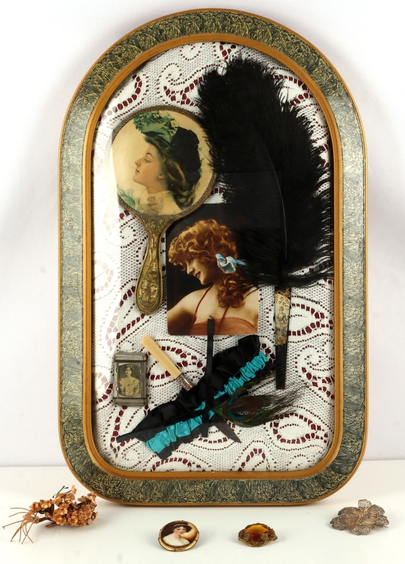 VICTORIAN PROSTITUTE ITEM DISPLAY SHADOW BOX: Shadow box of several items - including a photograph of a woman, a mirror with the face of a woman, a large feather hand fan, a garter with knife, and picture display mount holding the picture of a wo