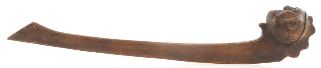 19TH CENTURY IROQUOIS HUMAN HEAD EFFIGY WAR CLUB: Human head effigy or figural ball club, 19th century. Carved from a single piece of wood with a distinct open-grain pattern. End of handle pierced for lanyard. 22.5 inches. Very good condition. Nose c