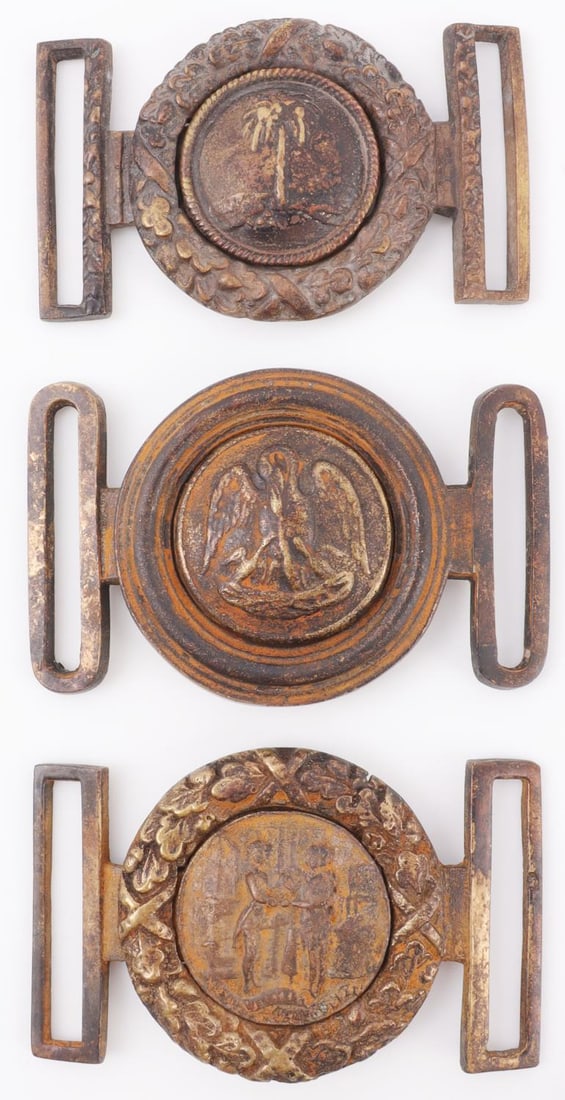 LOT 3 AMERICAN CIVIL WAR CONFEDERATE SASH BUCKLE: Lot of THREE (3). 1) Intact sash buckle with two men shaking hands, representing Kentucky. Buckle would have been specific to a quartermaster. Rust and patina. 3.25 X 2 inches. 2) Intact sash buckle w