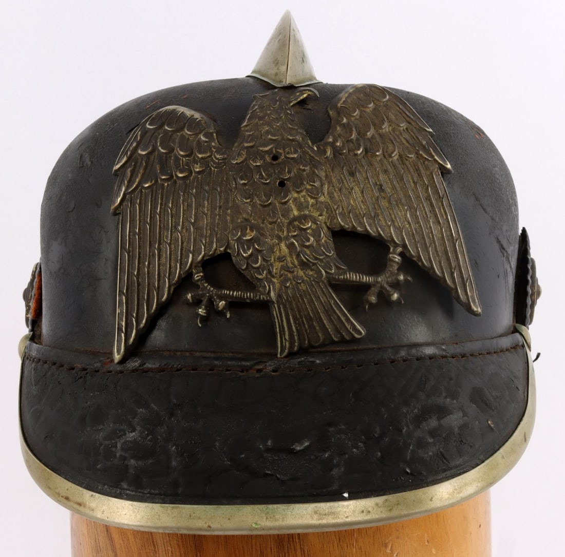 IMPERIAL GERMAN PRUSSIA FIRE SERVICE HELMET: Prussian Feuwehr leather helmet, ca. 1910. Size 58. Constructed like the Imperial German Pickelhaube. Retains eagle plate, rosettes, comb and leather liner. Missing neck cover and chin strap. Good con
