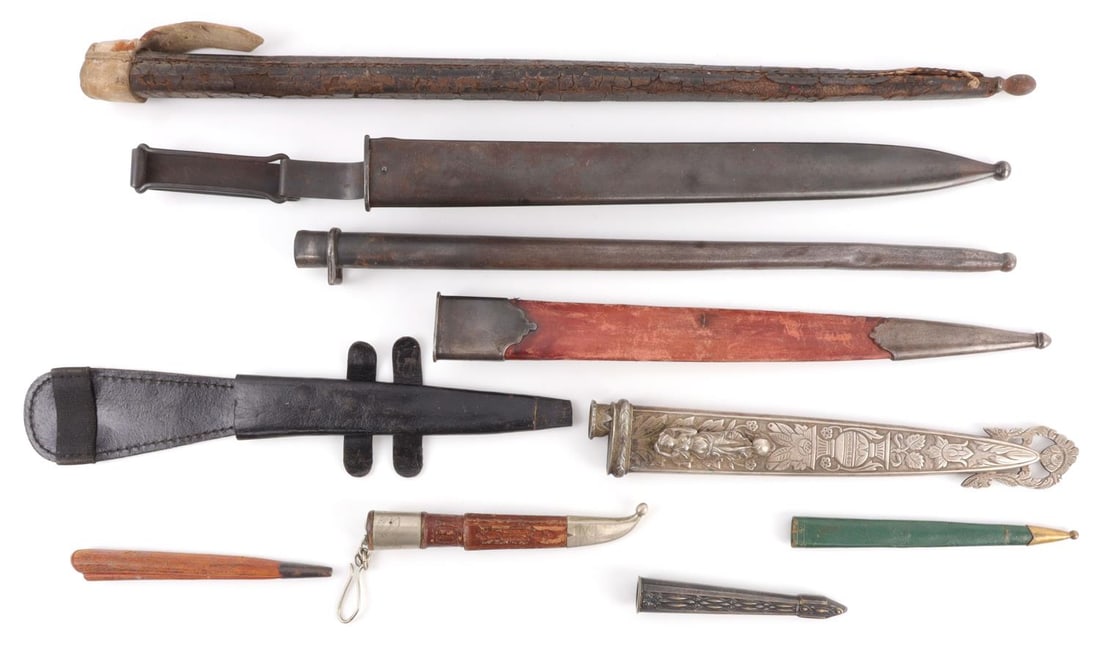 LOT OF 10 ASSORTED MULTI-WAR BAYONET SCABBARS: Lot of TEN (10) bayonets from various militaries, conflicts, and countries. Lot includes mostly European, Near Eastern, and North American actors. All scabbards are in good condition.