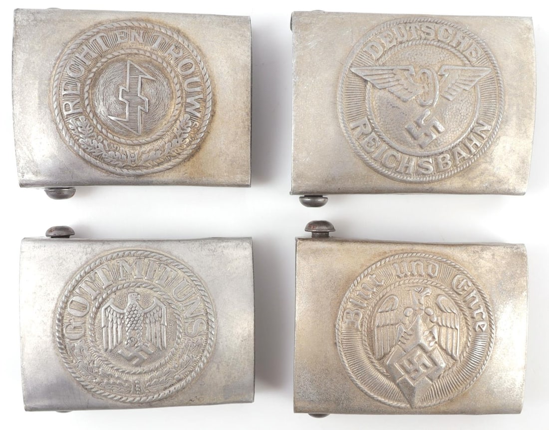 LOT OF 4 WWII GERMAN THIRD REICH BELT BUCKLES: Lot of FOUR (4). 1) Belt buckle with the angled swastika of the Hitlerjugend. 2.6 X 2 inches. 2) Belt buckle with wolfsangel and the phrase 'Recht en Trouw.'. 2.6 X 2 inches. 3) Belt buckle with the f