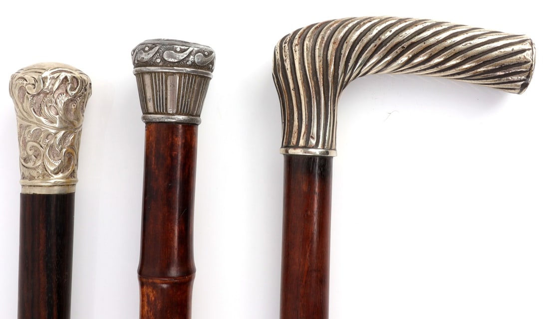 LOT OF 3 ANTIQUE SILVER GRIP WALKING STICK CANES: Lot of THREE (3) antique walking stick canes with silver grips, acid tested. 1) Bamboo shaft with silver knob, total length 34.75 inches. 2) Walnut shaft, total length 32.75 inches. 3) Pine shaft with