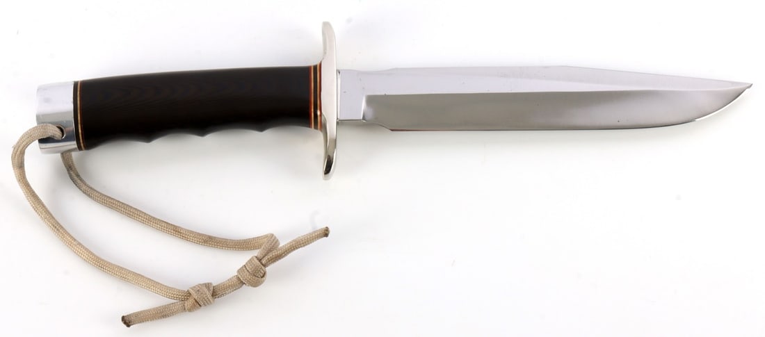 RANDALL MODEL 1 - 7 FIGHTING KNIFE: Carbon steel blade with Micarta grip. Crossguard is nickel and butt cap is duralumin. Overall length: 11.5 inches. Includes improper model 7 Johnson rough back sheath. This lot has a reserve.