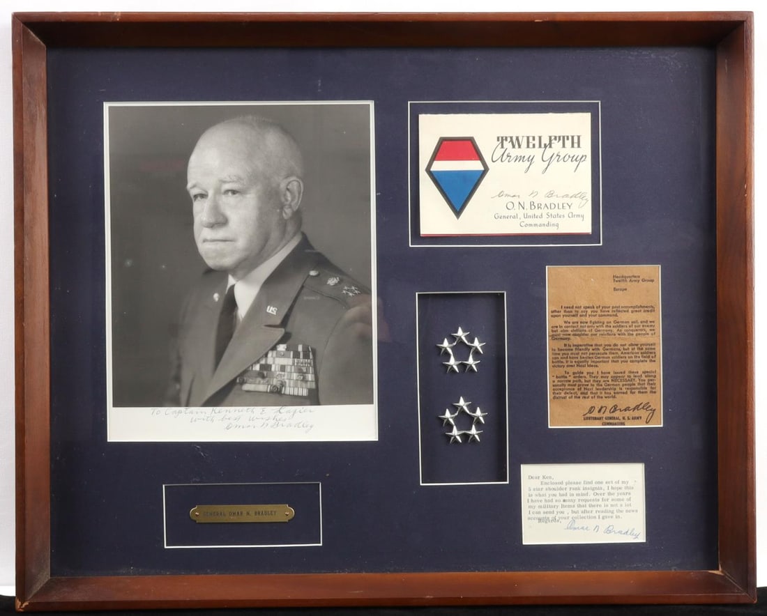 LOT OF WWII OMAR BRADLEY SIGNATURES & FIVE STARS: Display lot featuring several items related to Omar Bradley. 1) A pair of five star shoulder decoration for a General of the Army. 2) A name plate reading 'General Omar N. Bradley.' 3) A Twelfth Army 