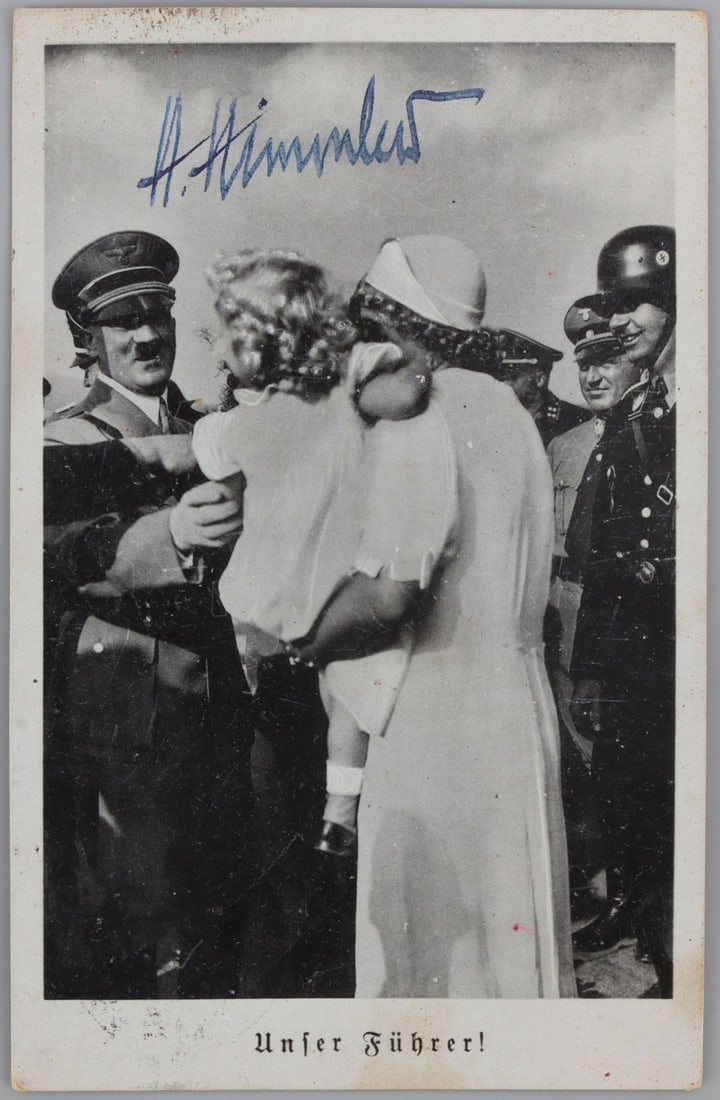 WWII GERMAN THIRD REICH HIMMLER SIGNED POSTCARD: Postcard with the signature of Heinrich Himmler over an image of Hitler meeting a child and the phrase, "Unfer Fuhrer." The back is an unrelated postcard with a Hindenburg stamp. 5.6 X 3.6 inches. Dee