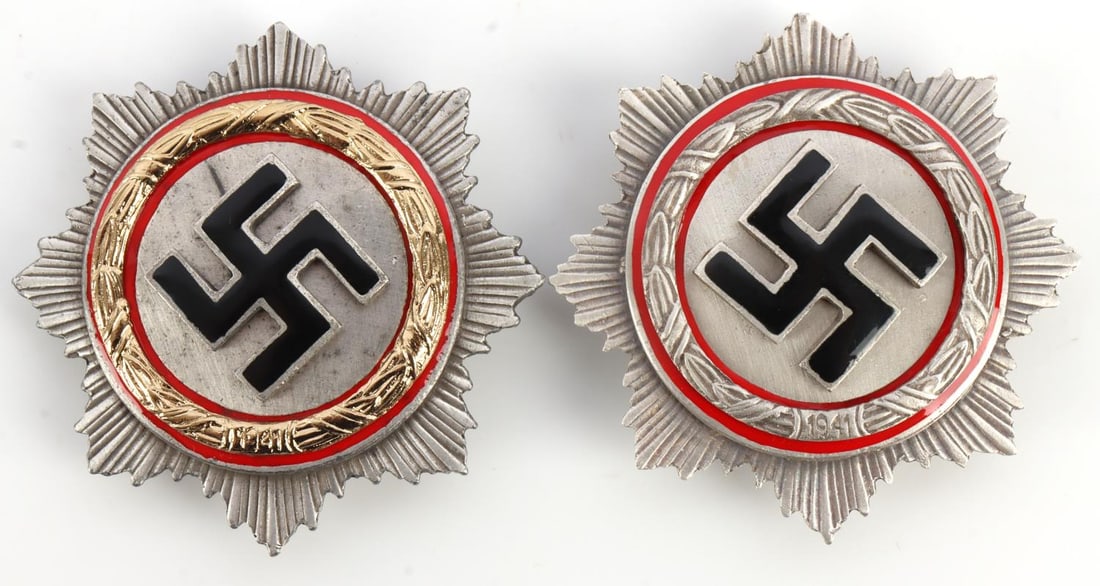 LOT OF 2 WWII THIRD REICH GERMAN CROSS GOLD SILVER: Lot of TWO (2). 1) German Cross in gold. Swastika over a corona with a ring of gold. Marked G. BREHMER MARKIIEUKIRCHEN. Flat pin back. 2) German Cross in silver. Swastika over a corona with a ring of 