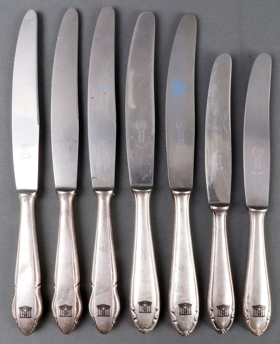 LOT OF 7 WWII GERMAN THIRD REICH SILVERWARE NSDAP: Lot of SEVEN (7) silver-plated knives stamped with the symbol for the Reichchancellory, a Reichsadler over columns. 8.5 inches each. Unauthenticated, sold "as is."