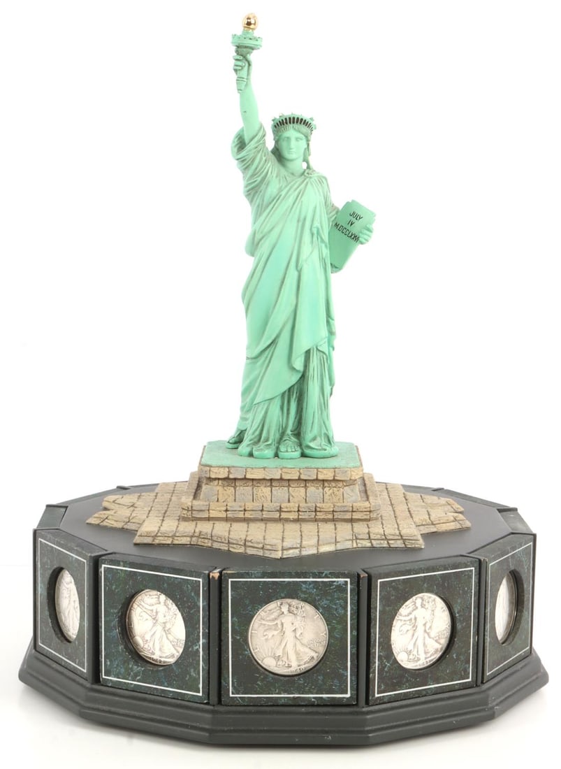 STATUE OF LIBERTY LIBERTY HALF DOLLAR DISPLAY SET: TWELVE (12) walking liberty half dollars displayed under a resin model of the Statue of Liberty. The crown of the statue has been damaged and the spikes are now missing. Display set has been made by t