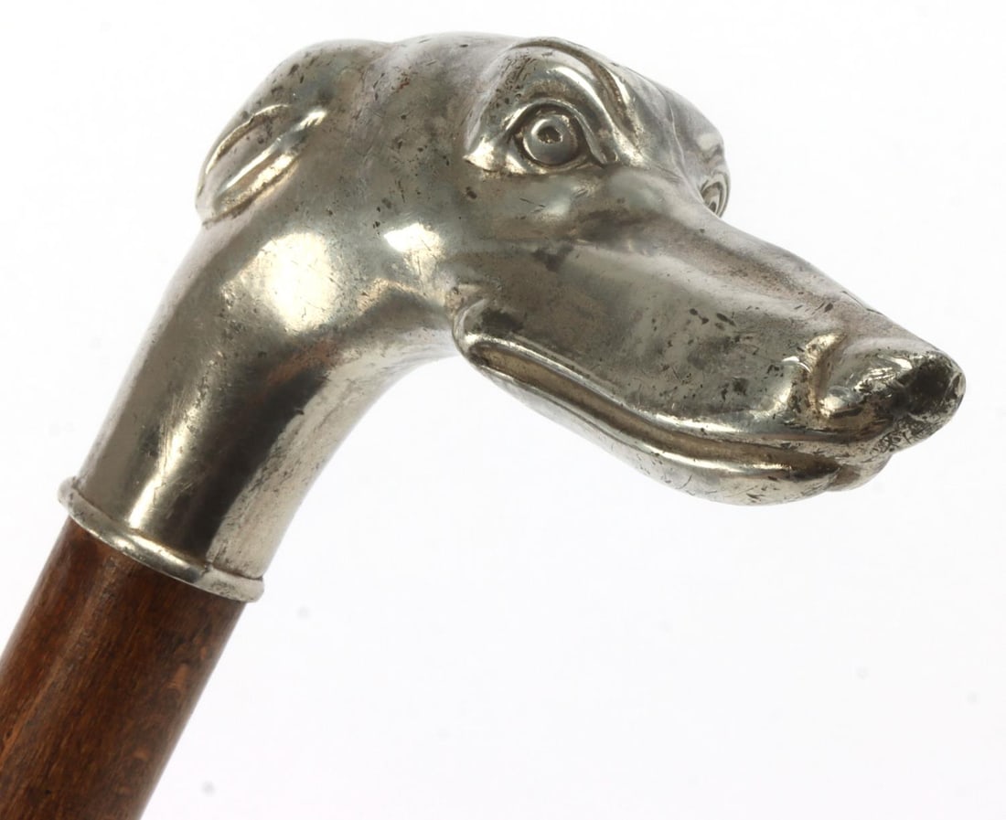 GREYHOUND DOG HEAD FIGURAL WALKING CANE: Dog's head figural knob, of non-magnetic alloy. Wood shaft with metal tip. Measures 34.25 inches long.