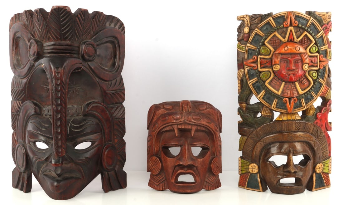 LOT OF 3 MESOAMERICAN CARVED WOOD SCULPTURE MASKS: These masks represent various Mesoamerican deities. Heights range from 8-15.25 inches. Very good condition. Unauthenticated, sold "as is."