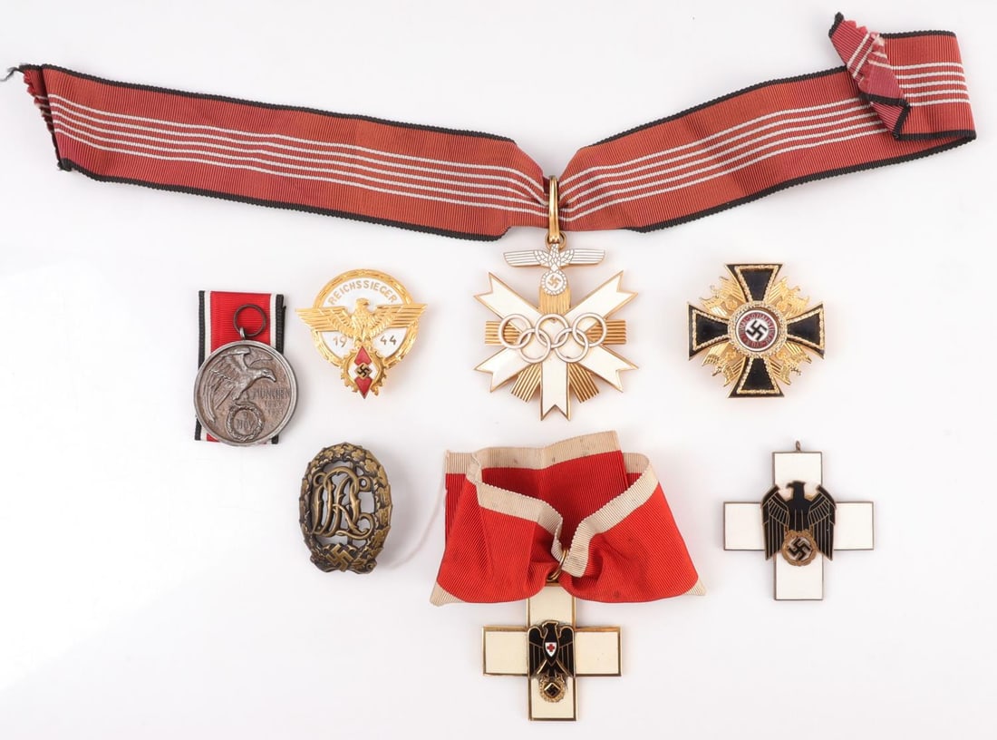 LOT WWII THIRD REICH CIVIC & PARTISAN MEDALS: 1) NSDAP Blood Medal with ribbon. 1.5 inch diameter. 2) DRL sports badge. 1.75 X 2.25 inches. 3) Social Welfare medal. 2.25 X 2.25 inches. 4) Hitler Youth national prize in gold. 1.75 inch diameter. 5
