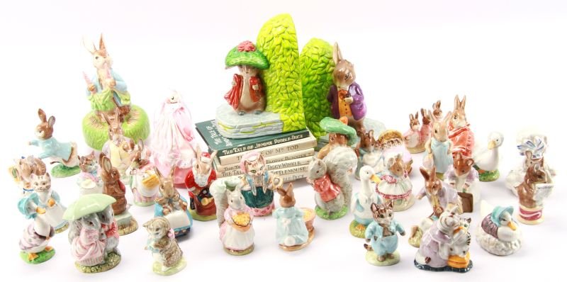 MIXED LOT OF BESWICK BEATRIX POTTER'S AND MORE: Lot Includes 30 pieces of Beswick Beatrix Potters (includes 4 ceramic stands, each holding five figurines), 1 piece of Royal Doulton Santa Bunnykins, Schmid Music Box , Schmid book ends, and 7 books b