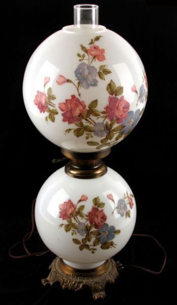 GONE WITH THE WIND STYLE ELECTRIC LAMP: An electric double globe lamp. 24 inches overall tall. Bottom globe is 9 inches in diameter and top globe is 10 inches. Floral transfers on front and back of both globes. Very good working condition.