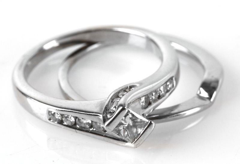 LADIES 14K WHITE GOLD DIAMOND BRIDAL SET: Low profile, bar set with a twist, containing one princess cut square shape diamond, measuring 3.5x3.5mm, for an approximate weight of .25ct, graded I/I1, with good make, bar set. Also, channel set in