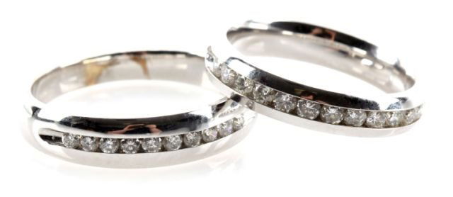 LADIES 14K WHITE GOLD WEDDING BAND W/ DIAMONDS: 4mm wide ring features twelve round brilliant cut diamonds each weighing approximately .04ct., totaling approximately 0.48cts., graded H/SI1-I1. Channel set for safe, snag proof wear. Size: 7.25 Weigh