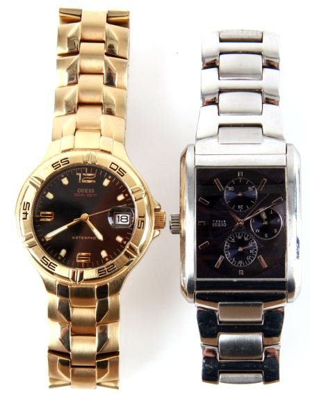 TWO MENS GUESS WRISTWATCHES: Two mens Guess watches; one gold plated "WaterPro" model, quartz date, water resistant to 100 meters, locking clasp on bracelet, black dial with luminous hands and position markers. One stainless stee