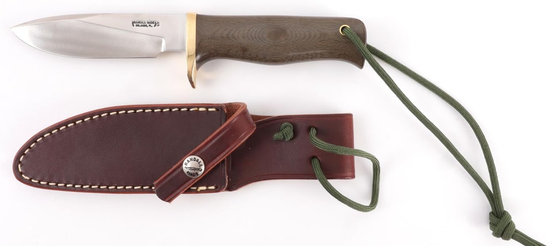 RANDALL MODEL 28 WOODSMAN KNIFE: Stainless steel 4 3/8-inch blade, green Micarta grip, brass finger guard. Thumb notch at top of knife. This lot has a reserve.