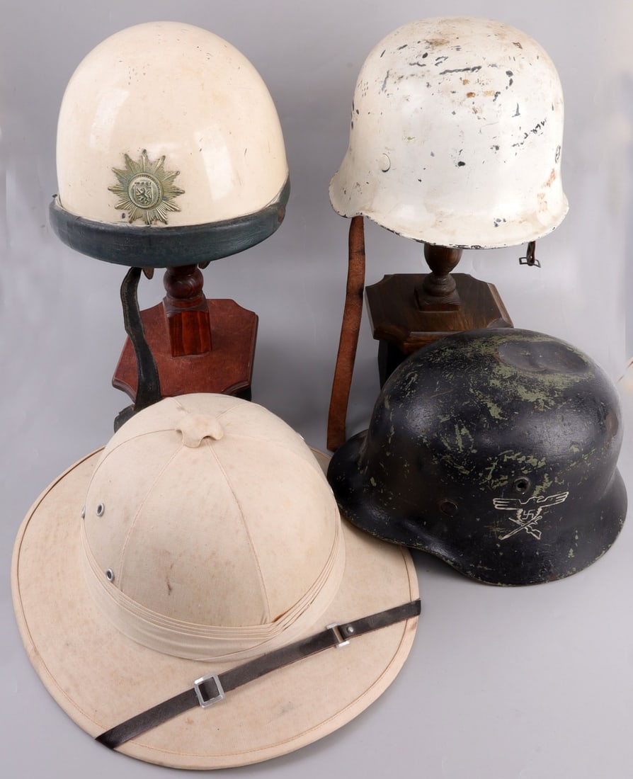LOT OF 4 HELMETS ITALIAN PITH BERLIN POLICE M40: Lot of FOUR (4) helmets. 1) Pith helmet is lightly stained, a wearable 7 1/4, 2) Berlin police helmet is about the same size, 3) WWII Police helmet is original (painted white), 4) M40 is a relic. Sold